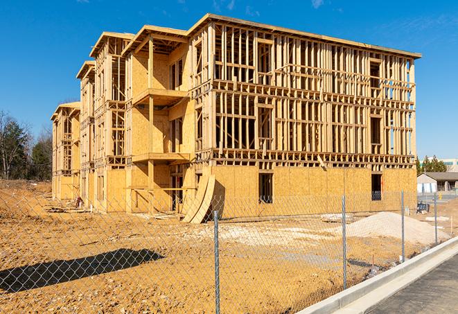 a close-up of temporary chain link fences enclosing a job site, signaling progress in the project's development in Auburndale